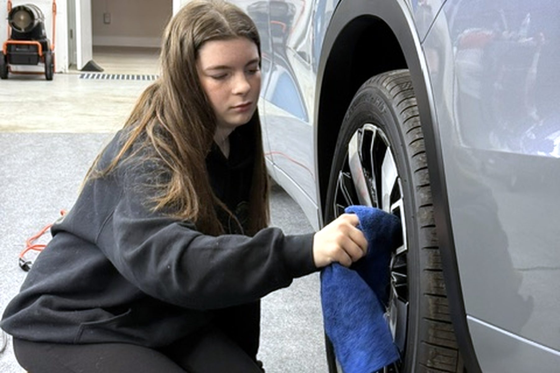 Wilmington Auto Detail technician deep-cleaning a wheel and tire — interior steam cleaning Wilmington NC