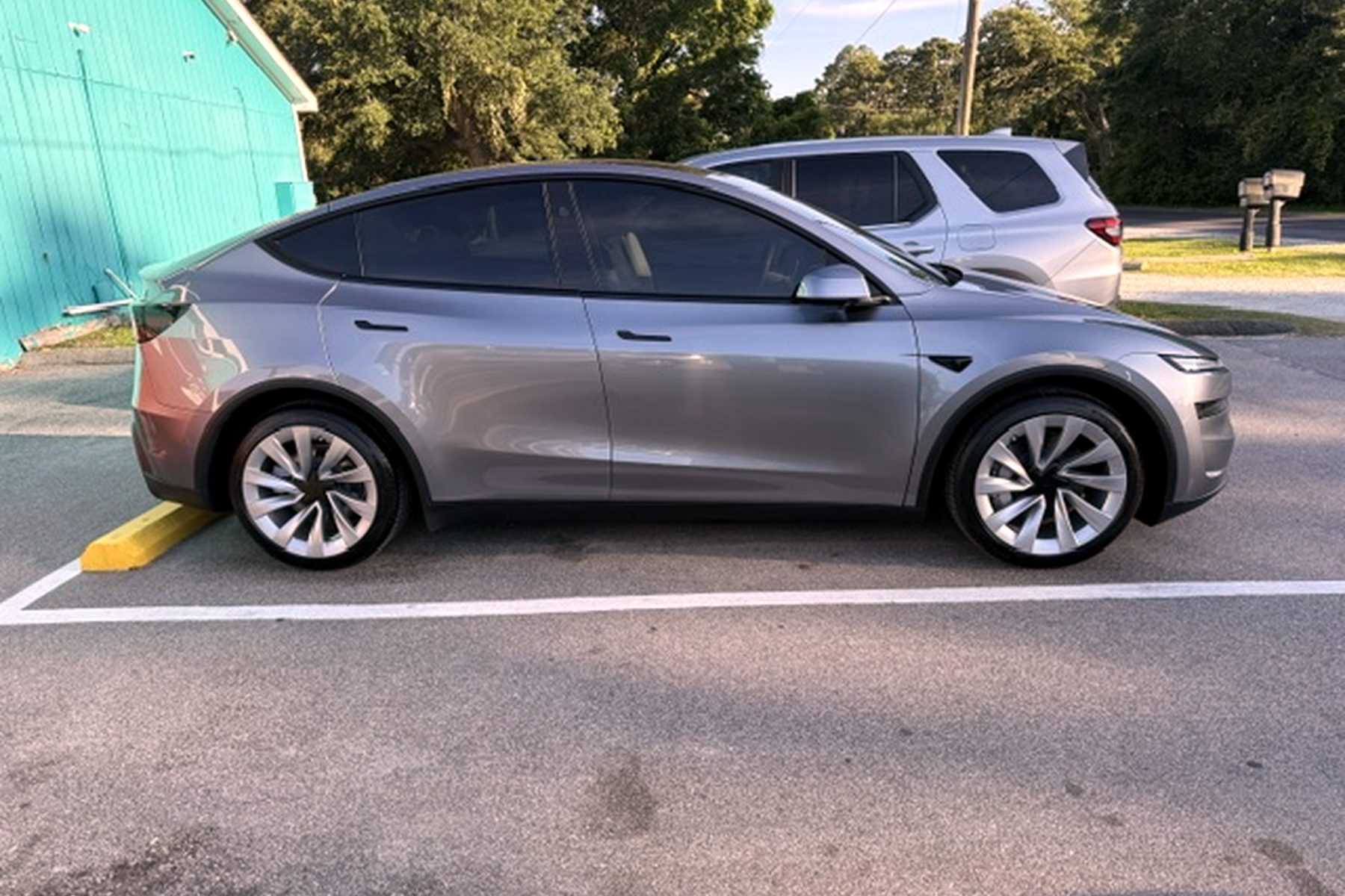 Glossy ceramic-coated Tesla Model Y parked outside the shop — ceramic coating Wilmington NC